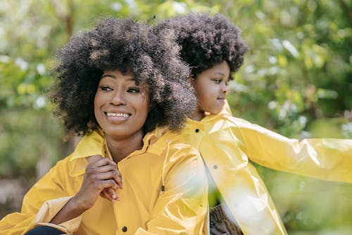 Shallow Focus of a Mother and Her Daughter Wearing Yellow Raincoat