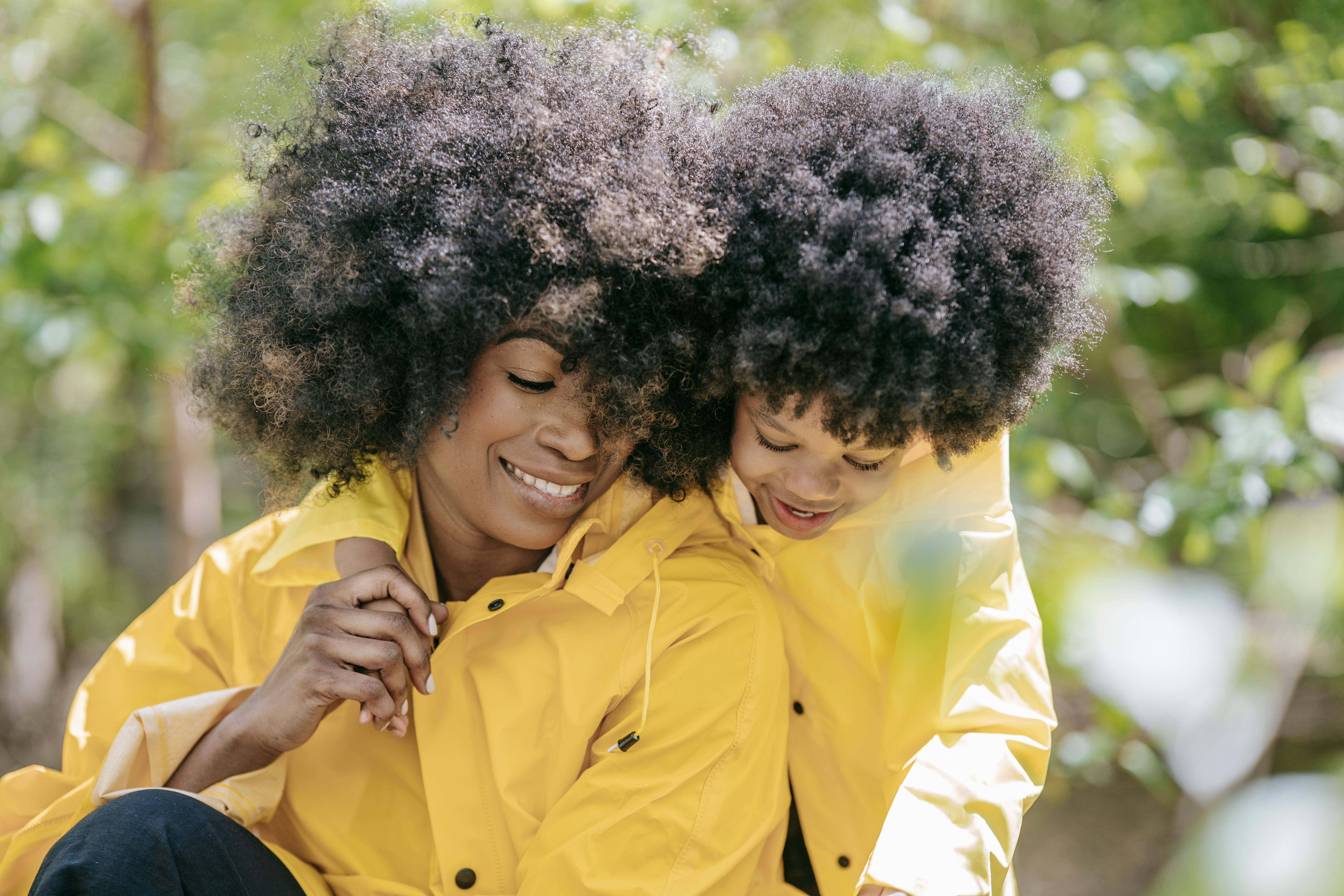 a woman and a child with matching raincoats