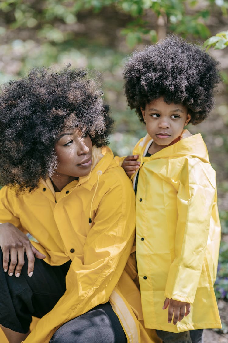 A Woman And A Child Wearing Yellow Raincoat