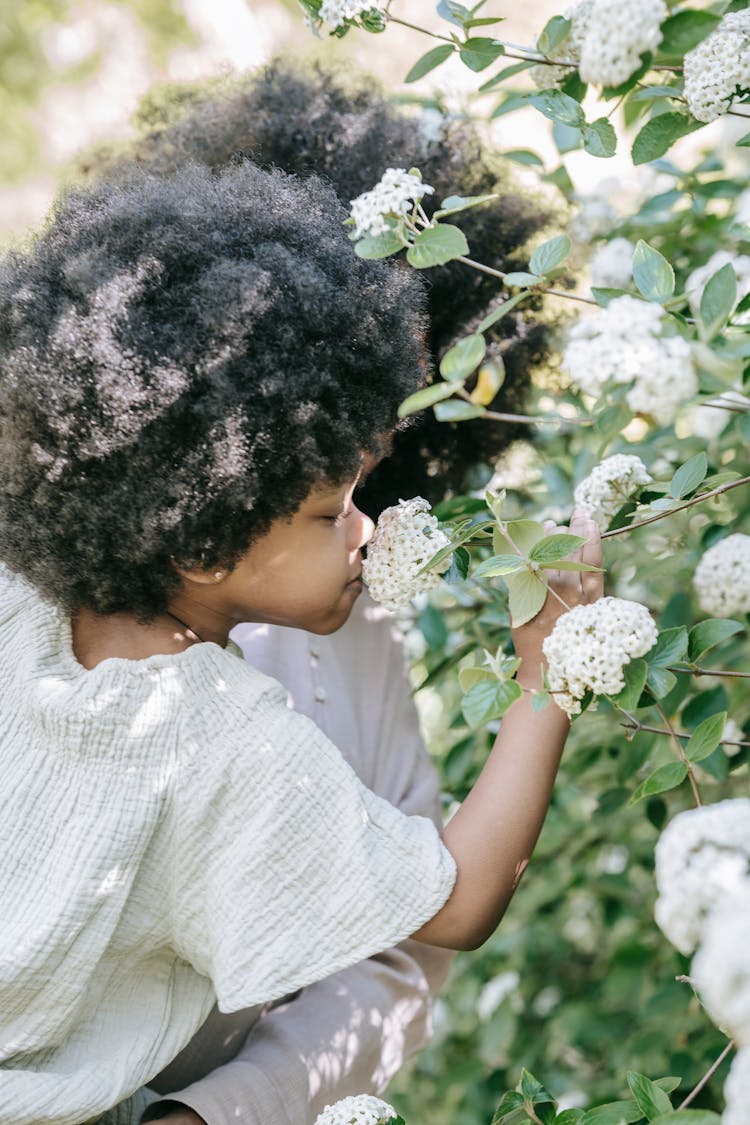 Boy Smelling Flowers