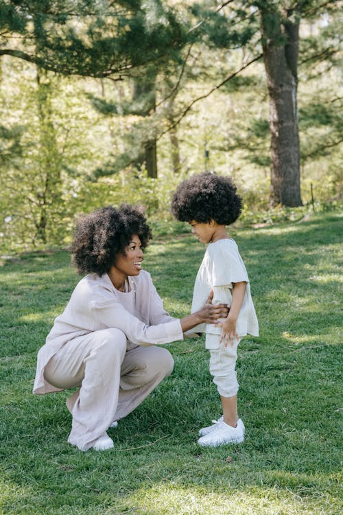 A Woman Talking to her Child at a Park
