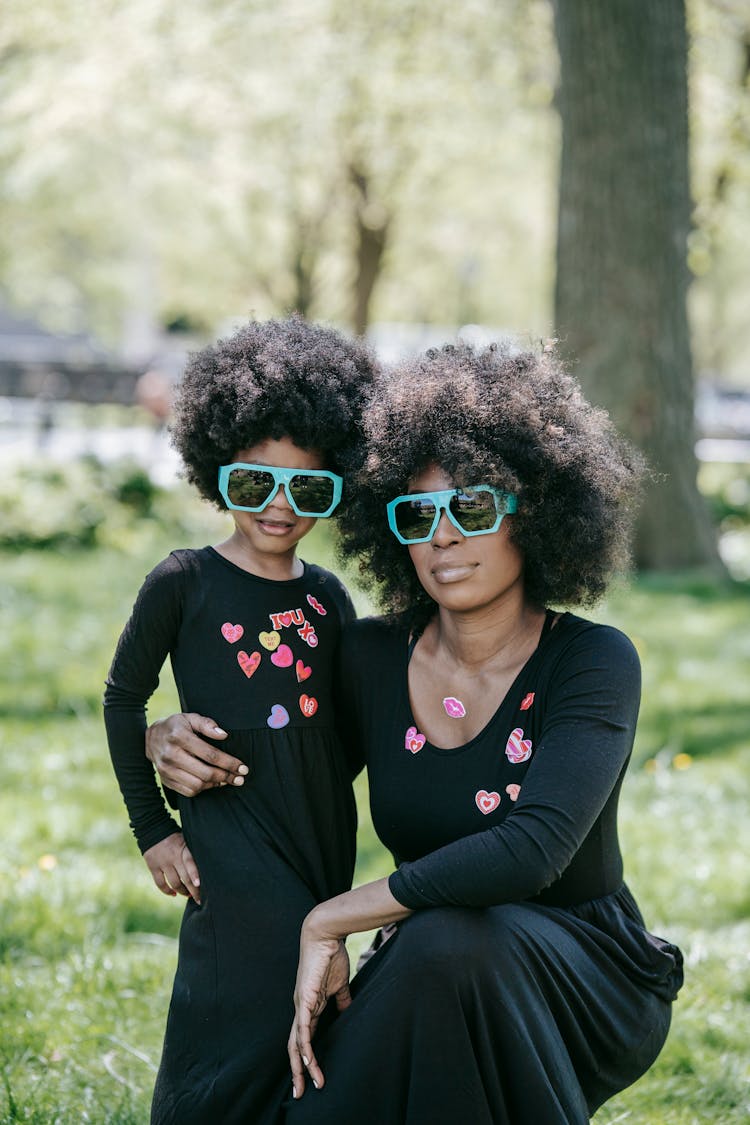 A Woman And Her Child In Matching Outfits