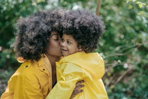 A Woman Kissing a Young Girl