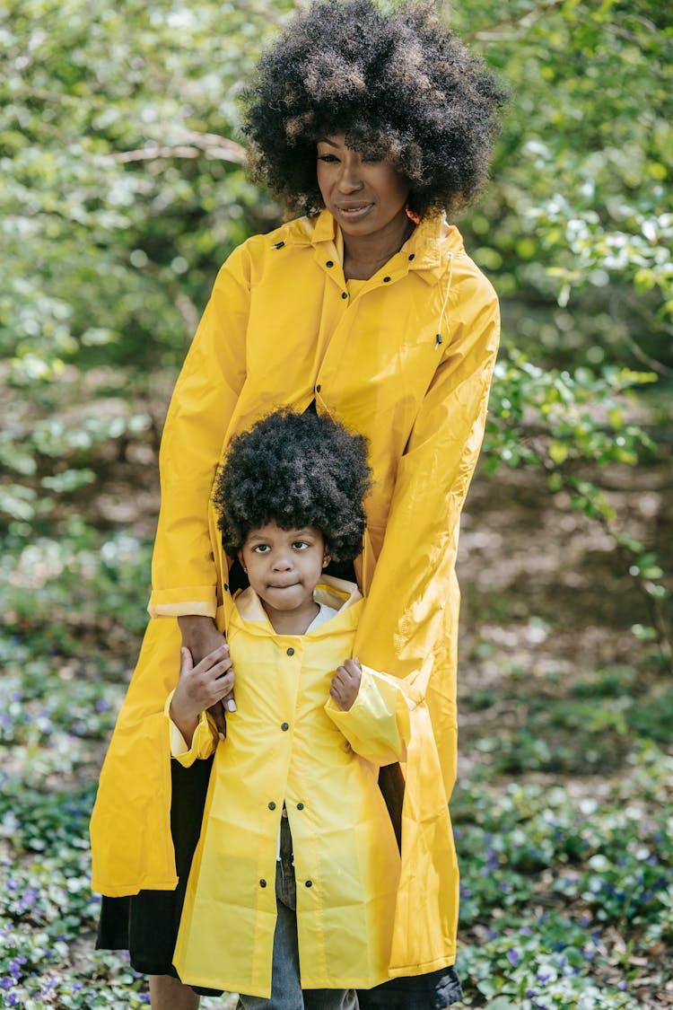 A Woman And A Child With Matching Raincoats