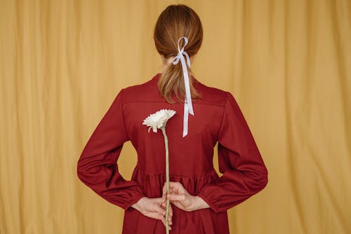Back View of a Woman Holding a Flower 