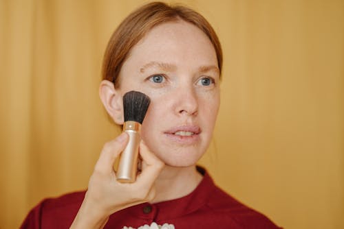 Free Close-up of a Woman Using a Makeup Brush Stock Photo