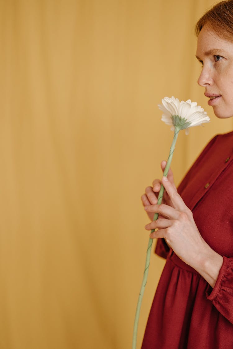 Woman Smelling A Flower