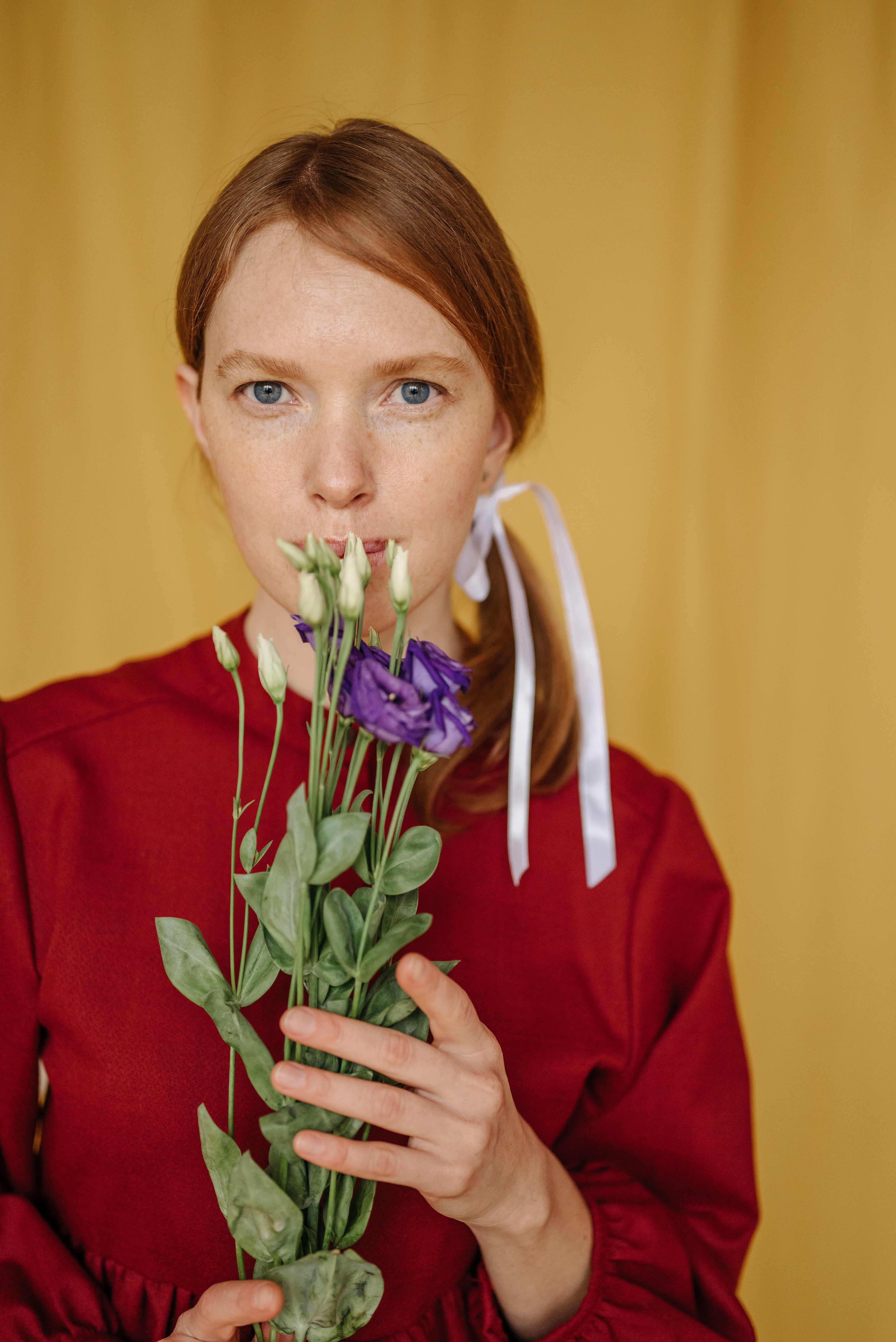 Woman in Red Long Sleeve Shirt Holding Flowers · Free Stock Photo
