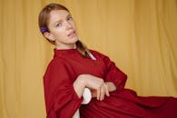 Woman in Red Sweater Sitting on Yellow Couch