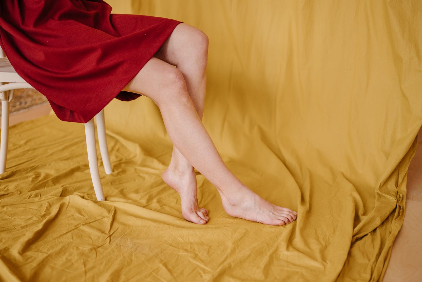 Person checking foot comfort while seated in bright natural light