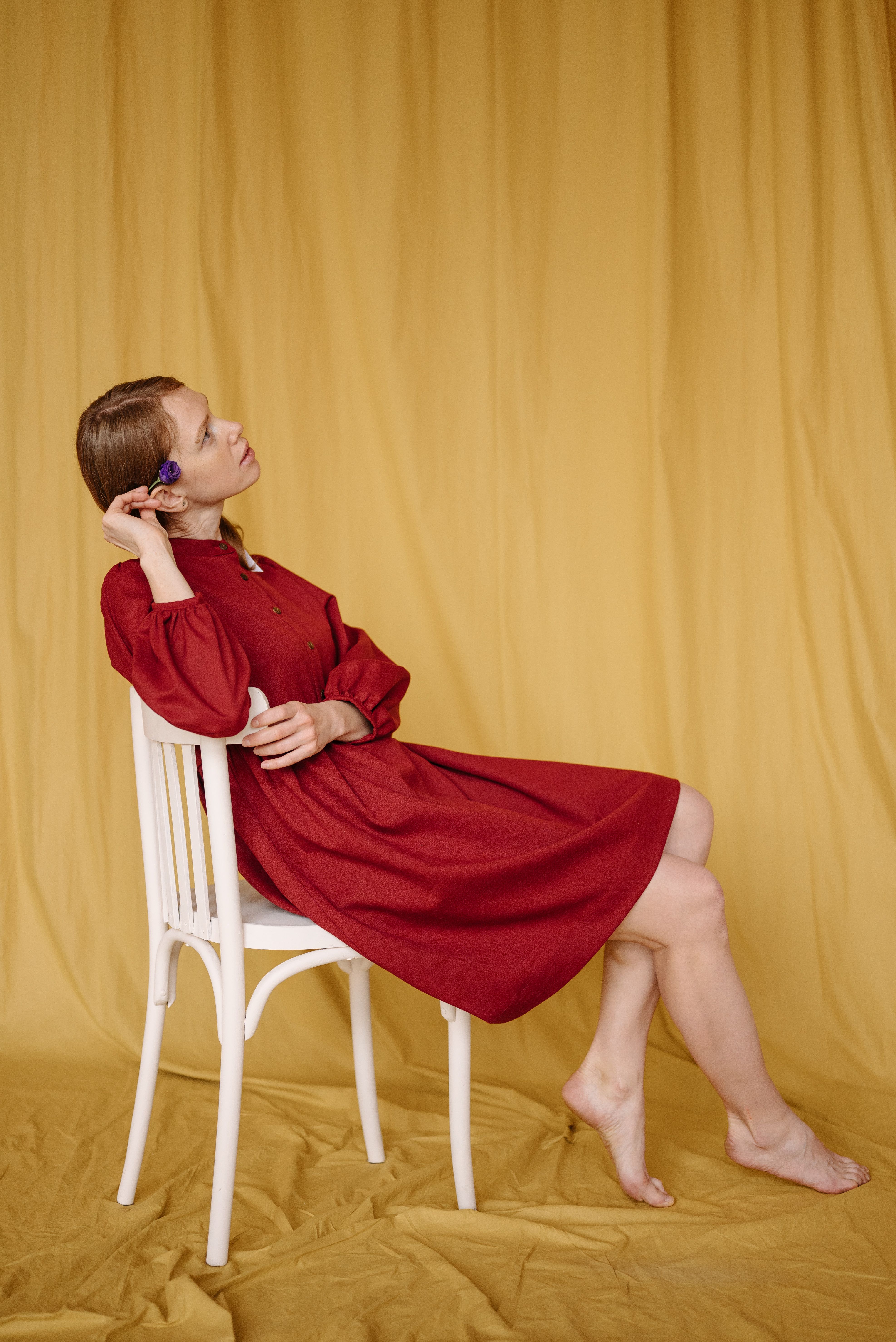 A Woman in Red Dress Sitting on a Chair · Free Stock Photo