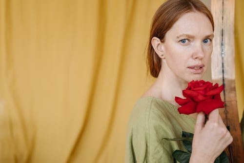 Free A Woman Holding a Red Rose Stock Photo