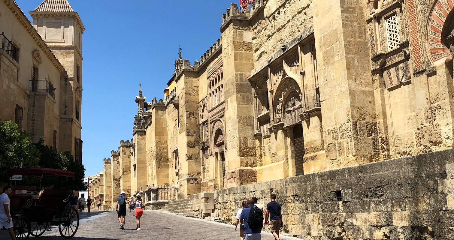 People Walking on an Alley Near a Mosque in Cordoba, Spain.