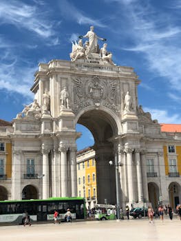 Stunning daytime view of Rua Augusta Arch, a historic landmark in Lisbon, Portugal.
