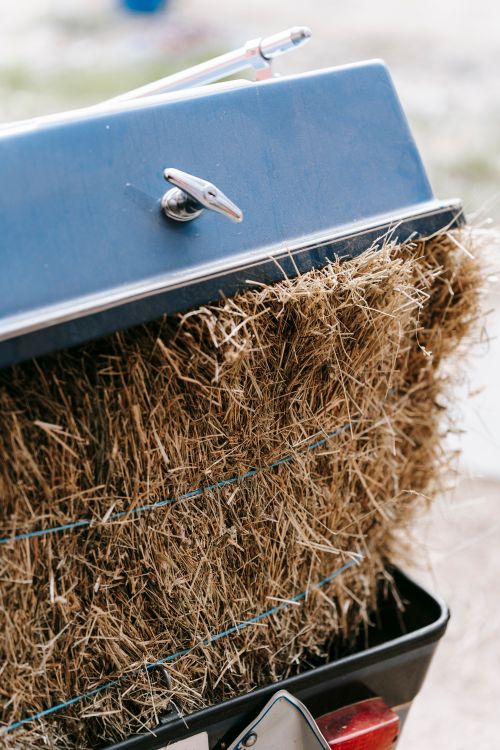 Free A detailed close-up of hay bales inside a blue metallic trailer, capturing texture and color. Stock Photo
