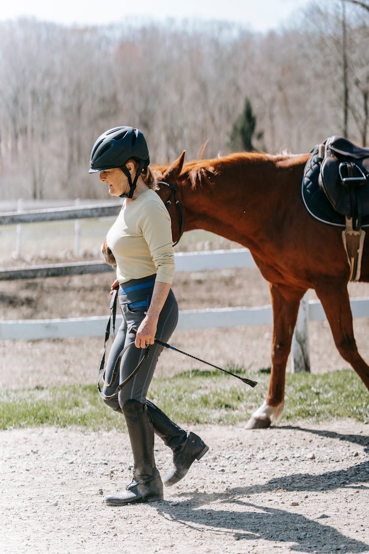 Woman Jockey Walking With Horse