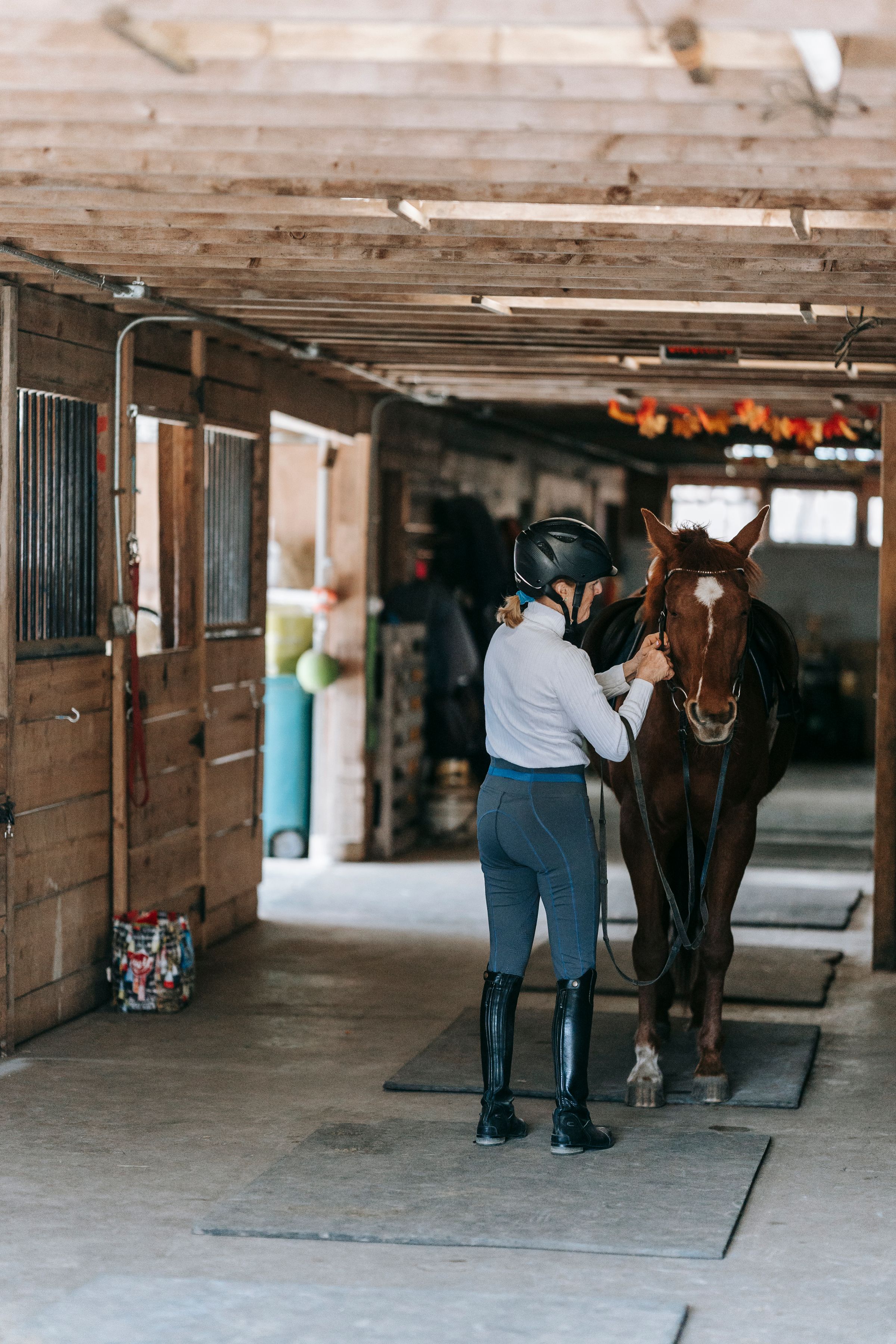 A woman standing quietly with her horse