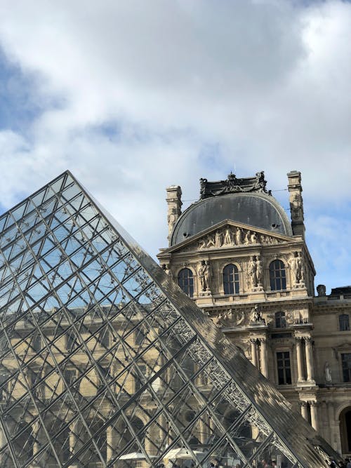 Free Louvre Pyramid beside an Old Building  Stock Photo