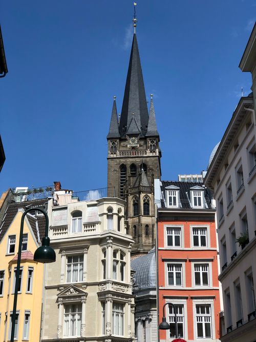 Free View of Aachen Cathedral surrounded by vibrant old town architecture under a clear sky. Stock Photo