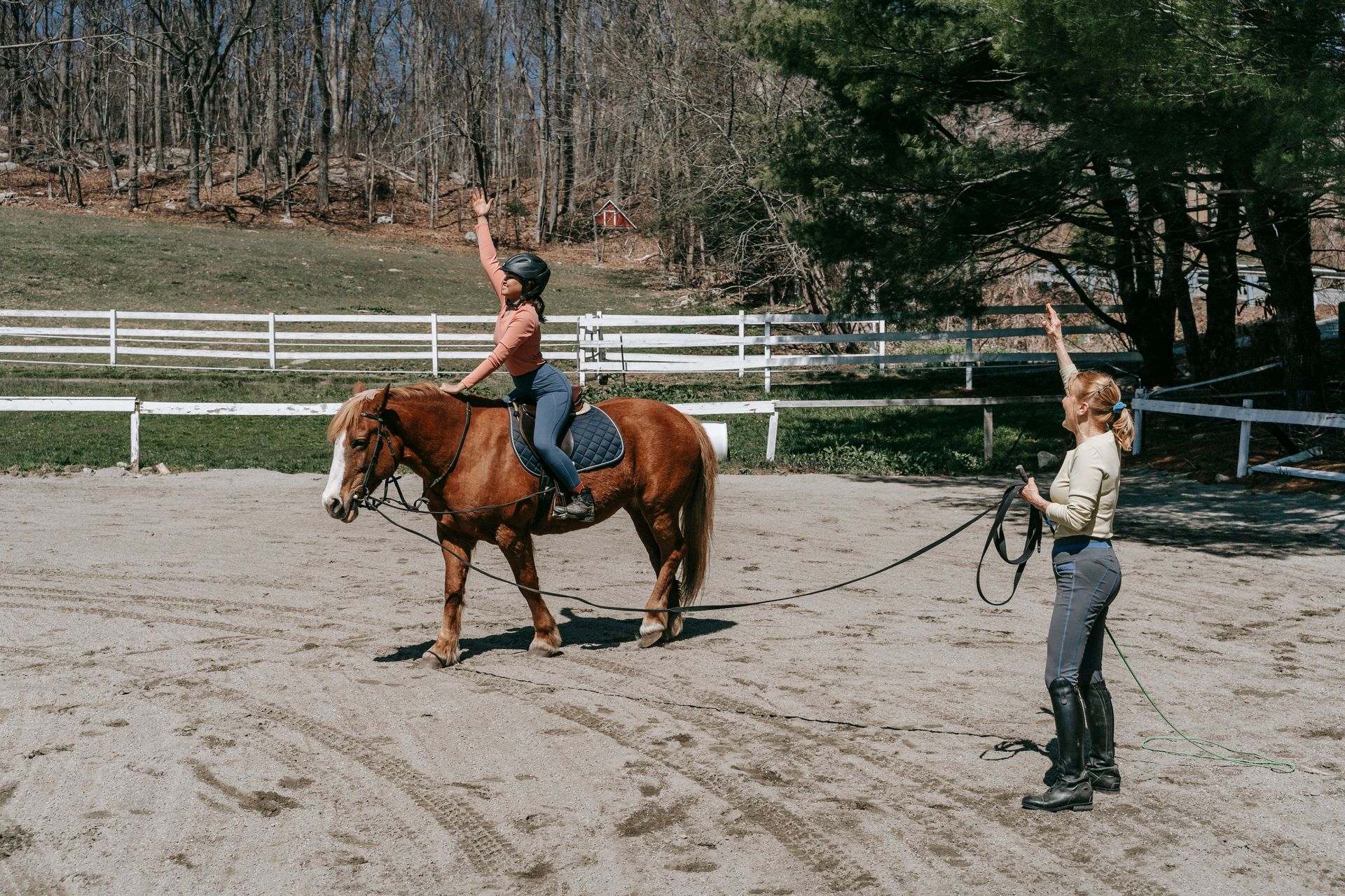 Photo of a Woman with a Black Helmet Riding a Brown Horse