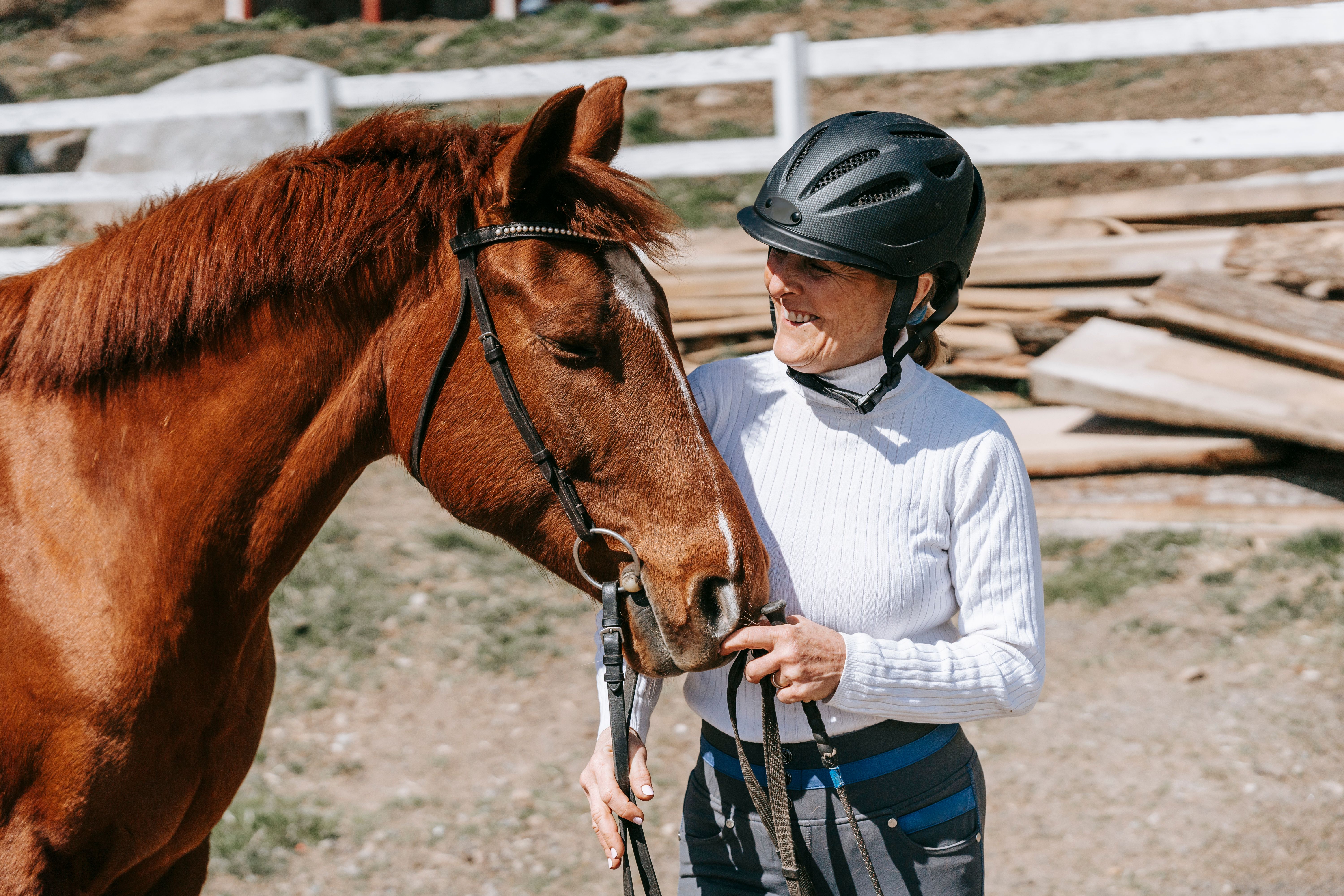 A Woman Standing Beside Her Horse · Free Stock Photo