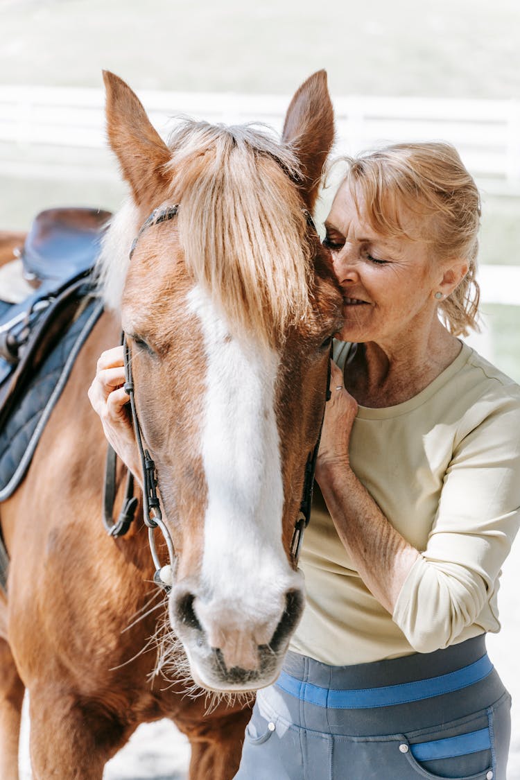 A Woman Hugging A Horse