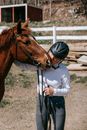 Person Wearing Riding Helmet Holding a Horse