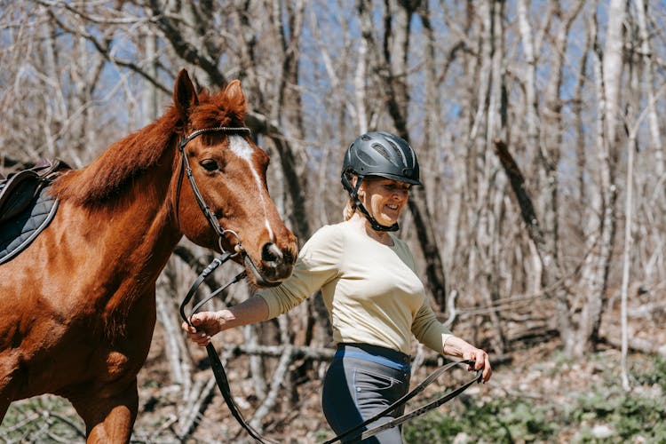 A Woman Leading A Horse