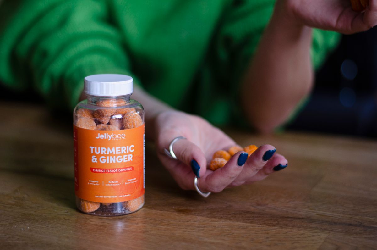 Close-up of a person holding nutrition gummies, emphasizing natural health supplements.