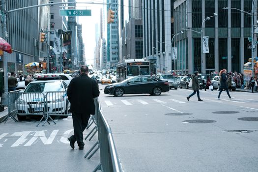 Urban street view of traffic and pedestrians in New York City's bustling W 48 St area.