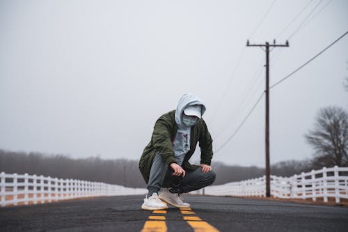 Stylish Man posing in the Middle of the Road