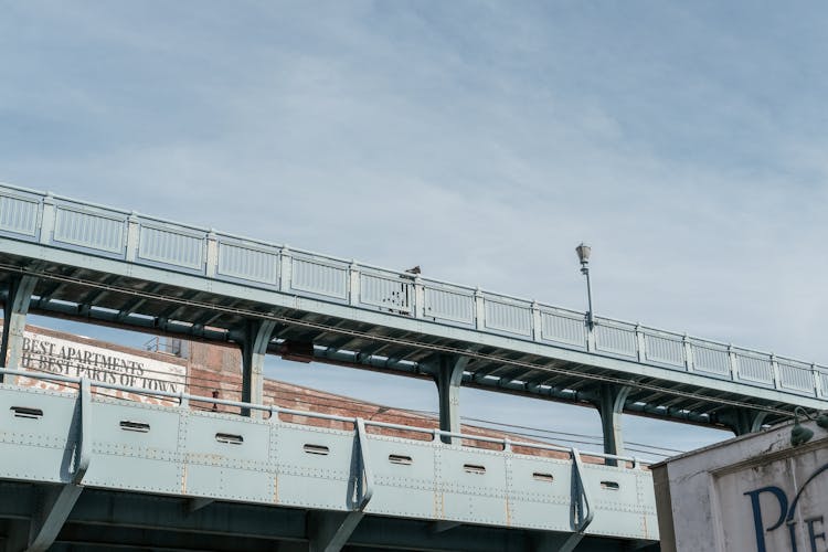 Person Riding A Bike On A Bridge