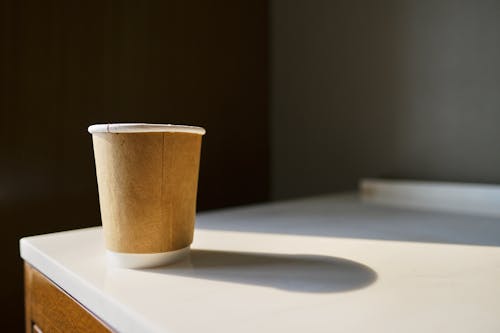 Brown Paper Cup on White Table