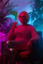 Photo of an Elderly Woman Sitting on a Sofa