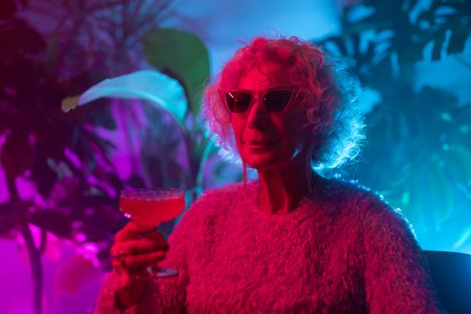 Photo of an Elderly Woman Holding Cocktail