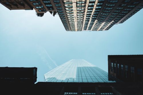 Free Looking up at the iconic skyscrapers of New York City against a blue sky. Stock Photo