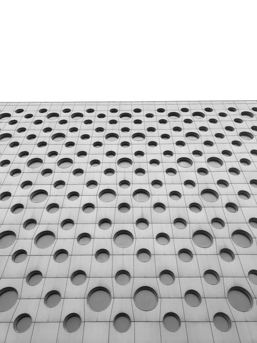 Free Black and white abstract photo of modern building facade with circular patterns in Kharkiv, Ukraine. Stock Photo