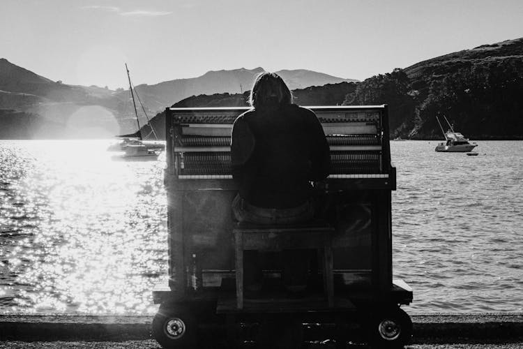 Person Playing The Piano Near Sea