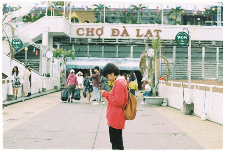 A Young Woman Standing On A Busy Street