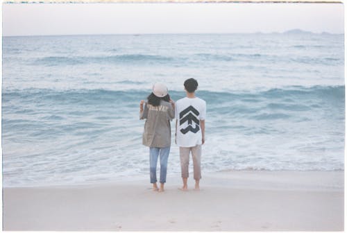 A Man and a Woman Standing at the Beach 