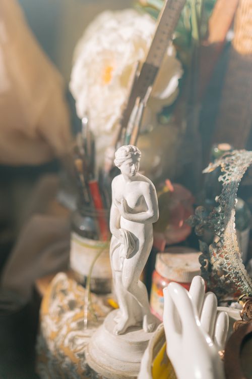 Free Beautiful handmade goddess figurine in a creative workspace, captured in a soft, artistic style. Stock Photo