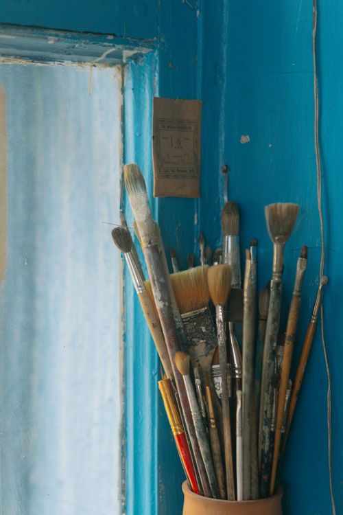 Paintbrushes in a jar in the studio