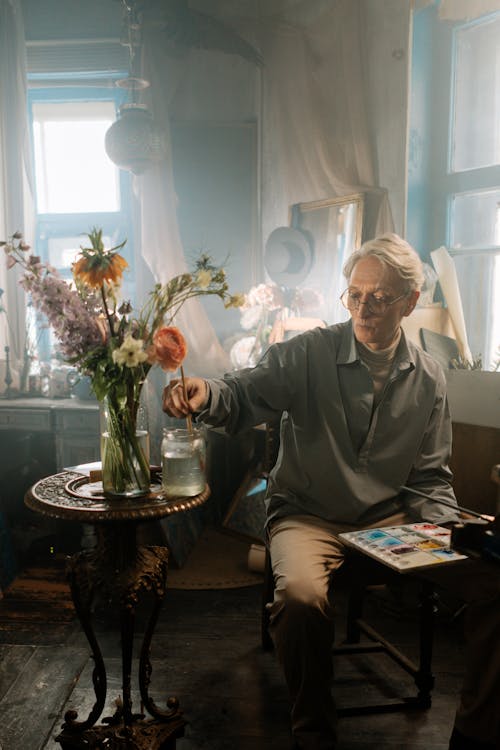 Man Holding A Color Palette and Paintbrush