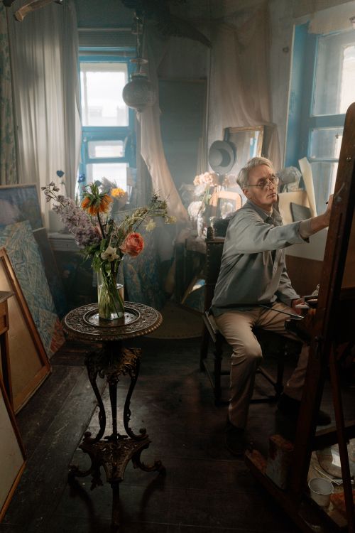Retired man absorbed in a hobby project in his home workshop