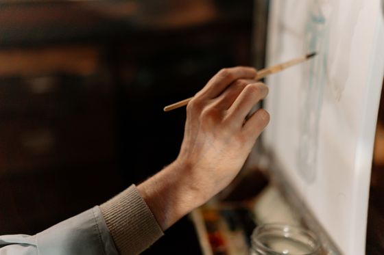 Hand painting on a canvas with a brush — photo by cottonbro studio on Pexels
