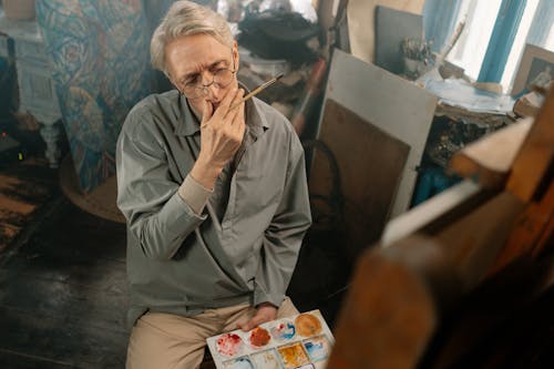 An Elderly Man Painting