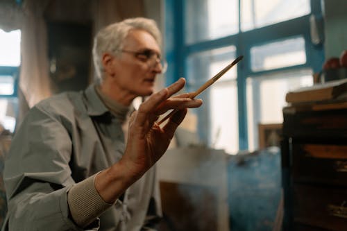 Elderly Man Holding A Paintbrush