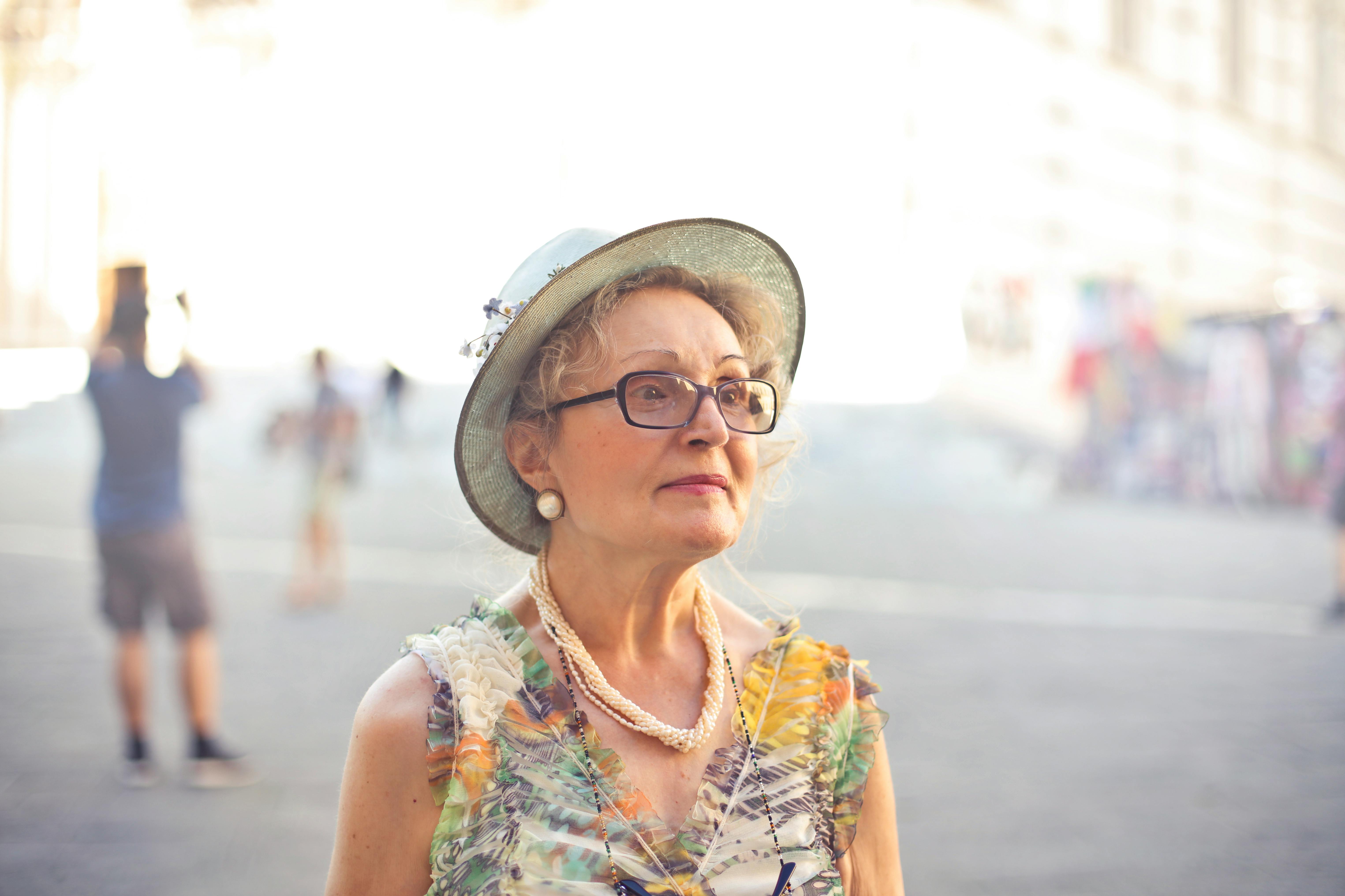 Woman in pastel color sleeveless shirt and sunhat. | Photo: Pexels