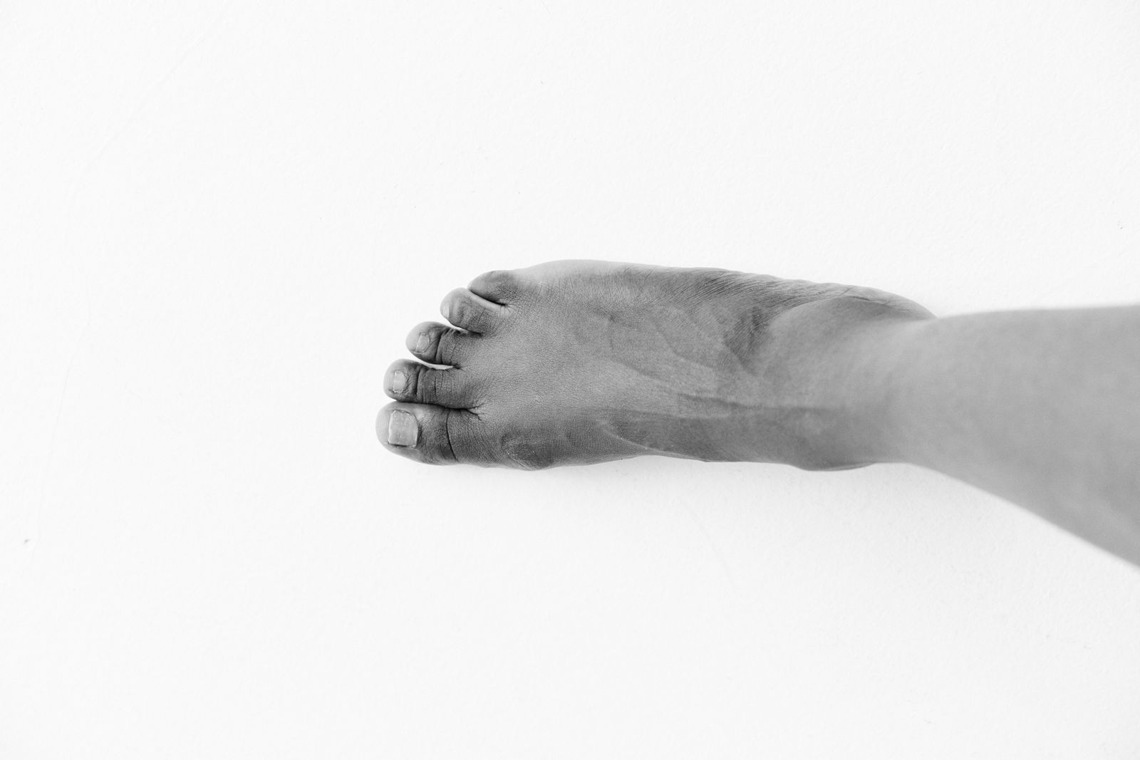 Person gently adjusting an ankle support after foot and ankle care