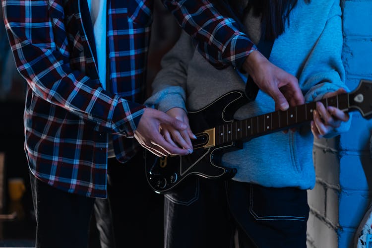 A Person Playing A Guitar Video Game